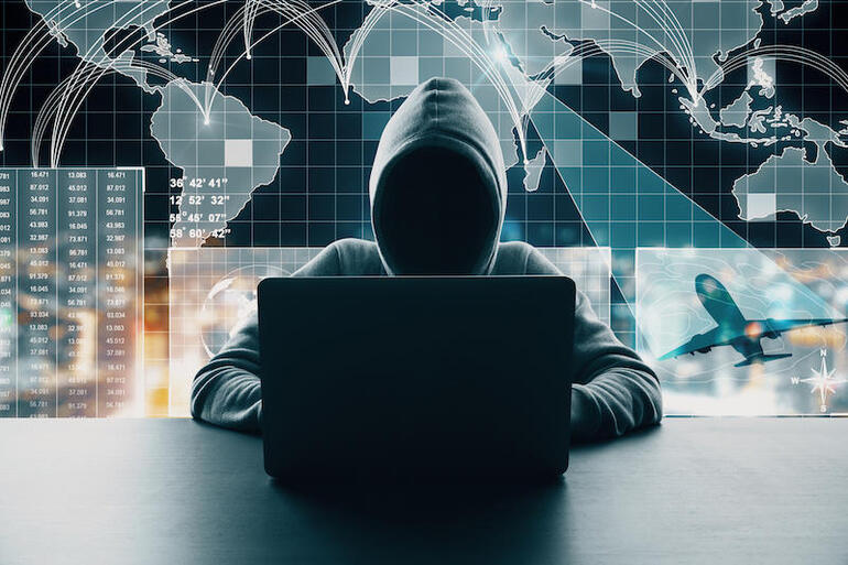 Hacker at desktop using laptop with abstract digital map interface on blurry background. Global network and travel concept. Multiexposure (Hacker at desktop using laptop with abstract digital map interface on blurry background. Global network and tra