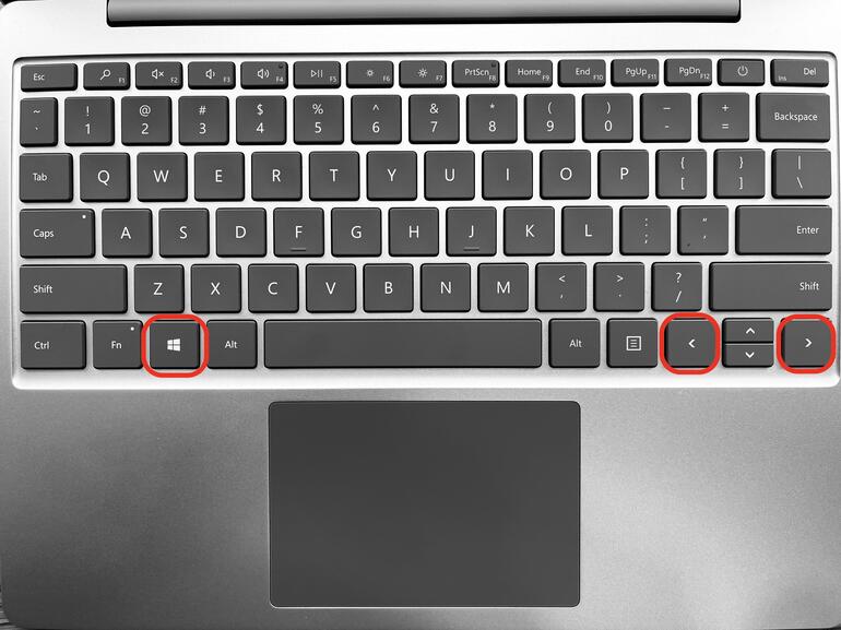 Photo of a Surface Laptop Go keyboard, with the Windows key, < and > keys circled in red.
