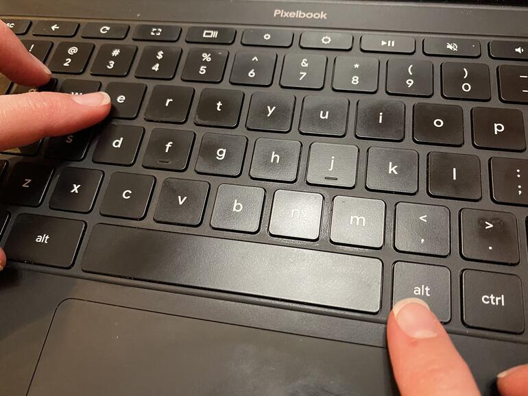 Photo with fingers on ALT key to the right of the space bar and another key about to press the e key.