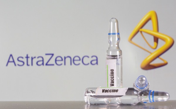 A test tube labelled with the Vaccine is seen in front of AstraZeneca logo in this illustration taken A test tube labelled with the Vaccine is seen in front of AstraZeneca logo in this illustration taken