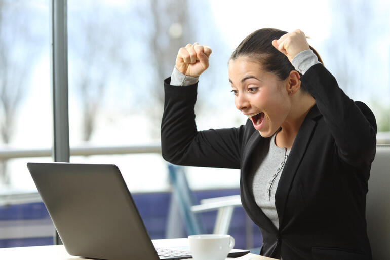 Excited woman at laptop