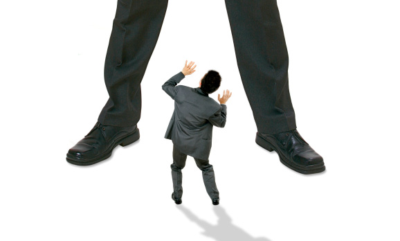 small person being threatened by much larger person