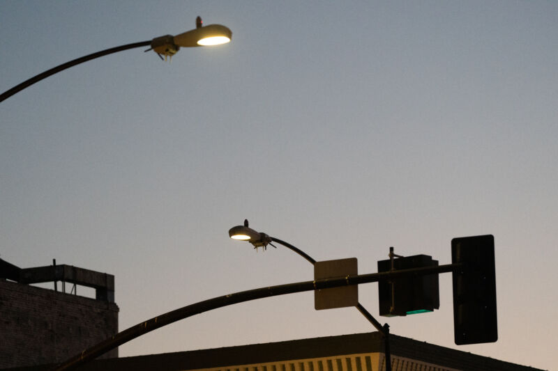 Two of San Diego's camera-equipped smart streetlights at twilight in August, 2020.