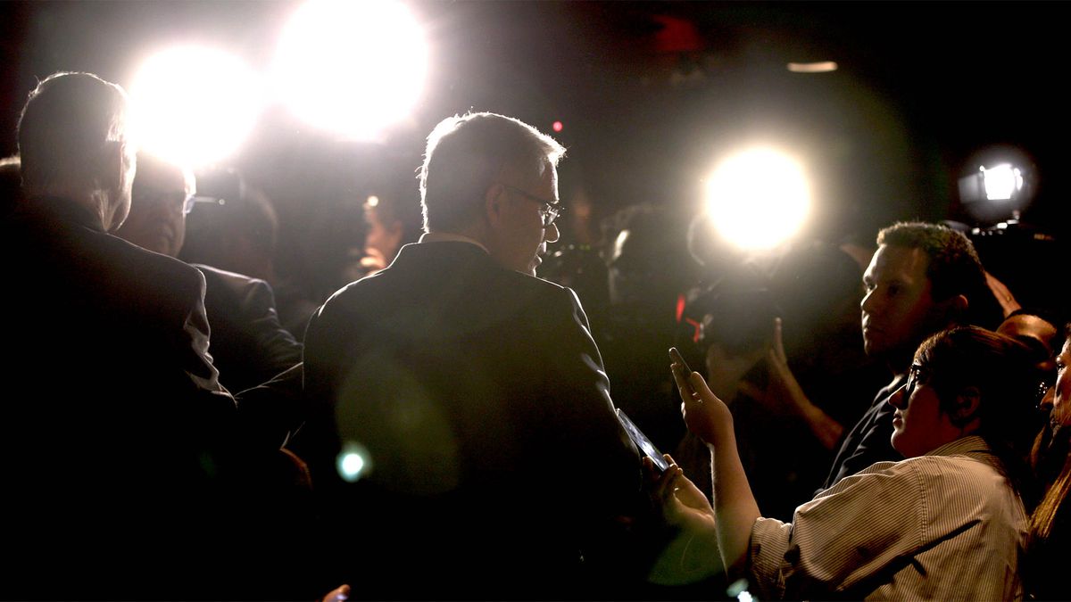 Philadelphia District Attorney Larry Krassner stands in front of a crowd of reporters.